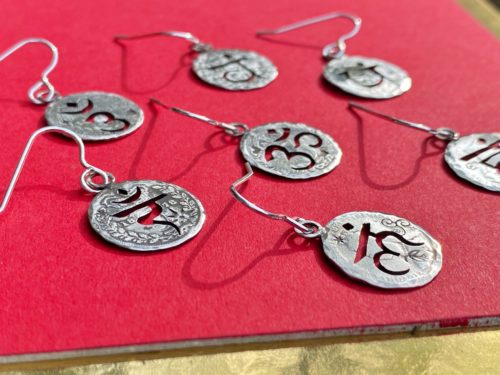 handcrafted and recycled silver threepence coin yoga earrings