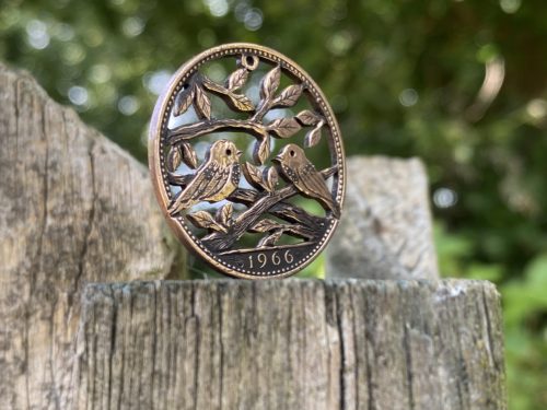 handmade and recycled 1966 penny with birds in tree singing