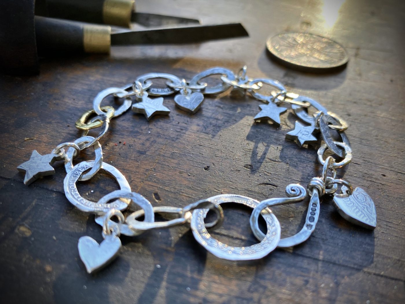 Personalised initials, hearts and stars bracelet individually handcrafted and recycled from an old Victorian silver coins and recycled ethical gold