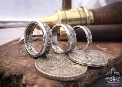Handmade and recycled silver coin rings being sized in the workshop
