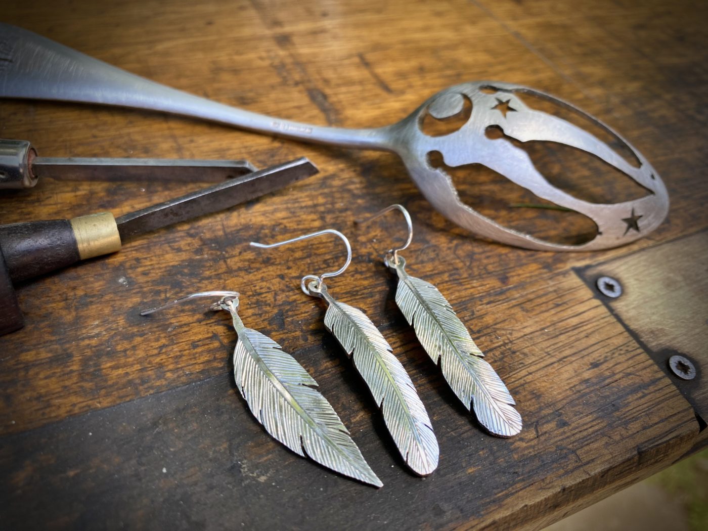 feather earrings made from recycled spoons